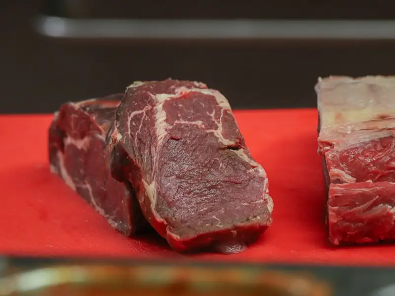 Cuts of raw beef on a cutting board